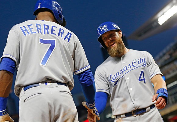 Alex Gordon of the Royals is congratulated by Rosell Herrera after Gordon scored on a single by Adalberto Mondesi in the sixth inning of Tuesday night's game in Minneapolis.