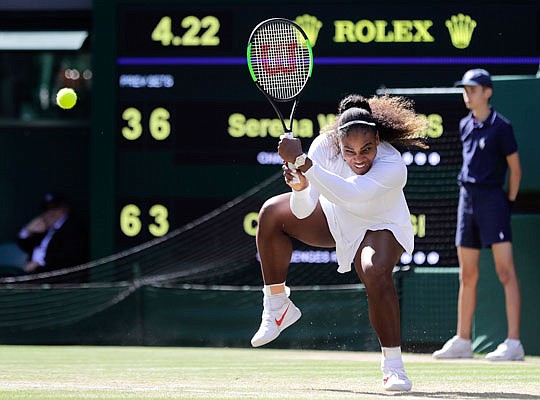 Serena Williams returns the ball to Camila Giorgi during their women's singles quarterfinal match Tuesday at the Wimbledon Championships in London.