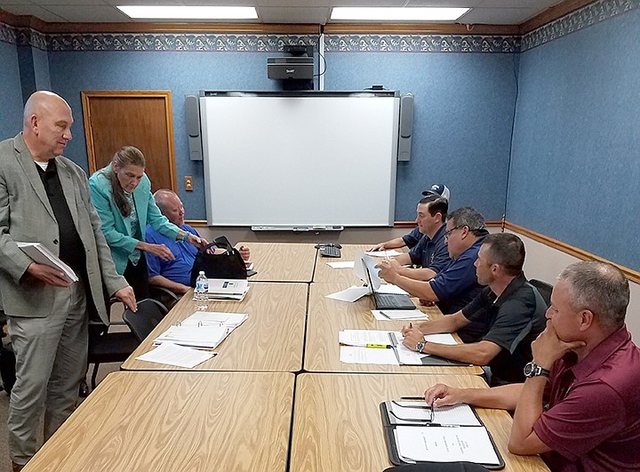 In this July 2018 file photo, Texarkana, Texas, officials and firefighters' union representatives gather for contract negotiations at City Hall.