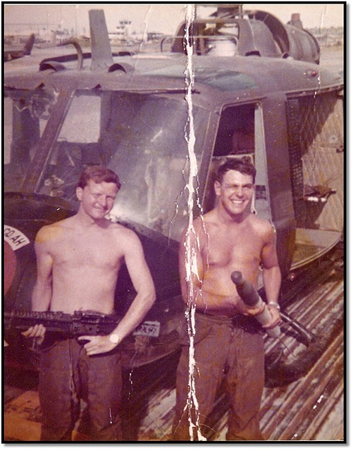 <p>Courtesy of Greg McManus</p><p>A 21-year-old McManus, left, is pictured in front of a UH-1 Iroquois “Huey” helicopter that he flew as a warrant officer during the Vietnam War.</p>