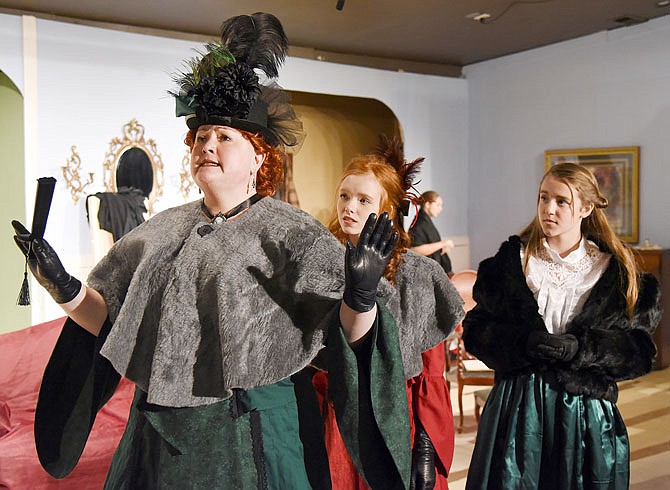 From left, Mrs. Gardener, played by Tammy Mallory, along with her daughter Sallie Gardener, played by Claire McMillian, and her friend Annie Moffat, played by Erin Lammers, walk across the stage Monday during a rehearsal of "Little Women" at the Stained Glass Theatre.
