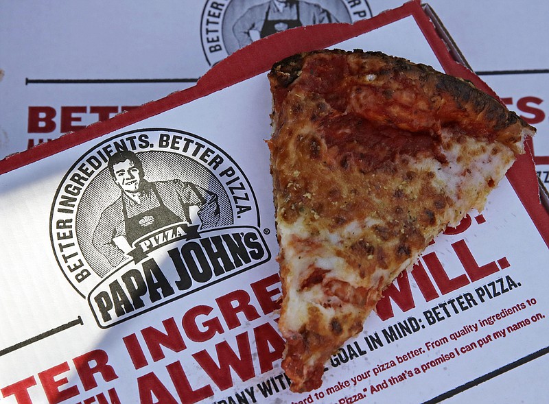 FILE- This Dec. 21, 2017, file photo shows a slice of cheese pizza at the Papa John's pizza shop in Quincy, Mass. Papa John’s plans to pull Schnatter’s image from marketing materials after reports he used a racial slur. Schnatter apologized Wednesday, July 11, and said he would resign as chairman after Forbes reported that he used the slur during a media training session. Schnatter had stepped down as CEO last year after criticizing NFL protests. (AP Photo/Charles Krupa, File)