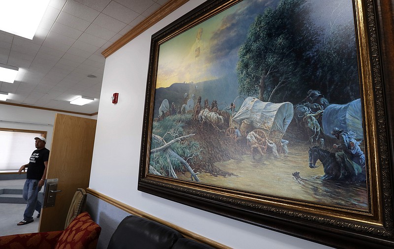 A large painting depicting the westward migration of Mormons hangs in the Zion's Most Wanted Hotel, which was built in Colorado City as a residence for Warren Jeffs, the leader of sect called the Fundamentalist Church of Jesus Christ of Latter-Day Saints. The community of about 5,000 people was once home to Jeffs and his sect. Jeffs was convicted in 2011 of two felony counts of child sexual assault. He was sentenced to prison for life plus 20 years. (Luis Sinco/Los Angeles Times/TNS)