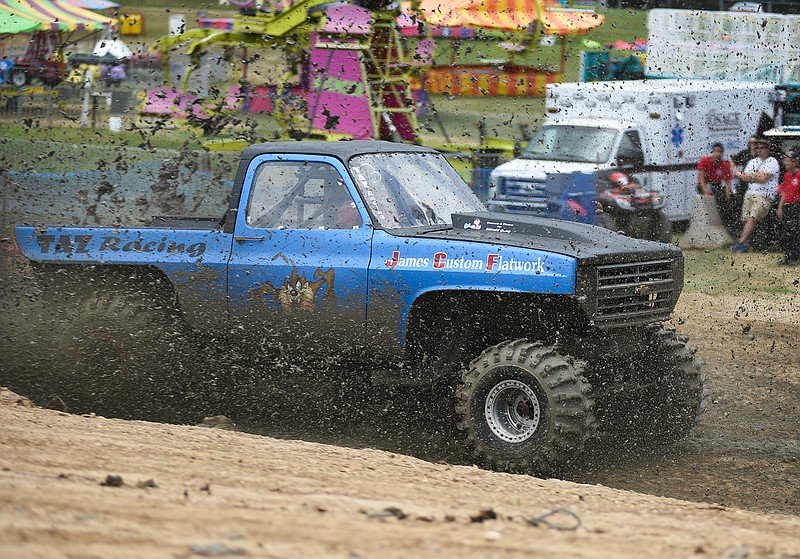 
Karen Littrell speeds through the mud in her TAZ Racing truck as a part of the first round of female drivers during Mud Bowl 28 at the Osage County Fairgrounds on Saturday, July 14, 2018 in Linn, Mo. Littrell hit a time of 4.4 seconds on going through the mud run.