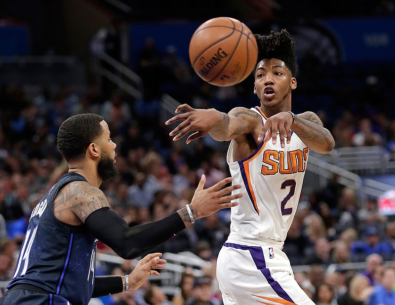 In this March 24, 2018, file photo, then-Phoenix Suns' Elfrid Payton passes the ball around Orlando Magic's D.J. Augustin, left, during the second half of an NBA basketball game, in Orlando, Fla. Payton and Julius Randle know very well they likely wouldn't have wound up in New Orleans if the Pelicans hadn't lost DeMarcus Cousins and Rajon Rondo in free agency. Randle and Payton are less accomplished, but younger and eager to see if playing alongside Anthony Davis helps them reach new plateaus.(AP Photo/John Raoux, File)