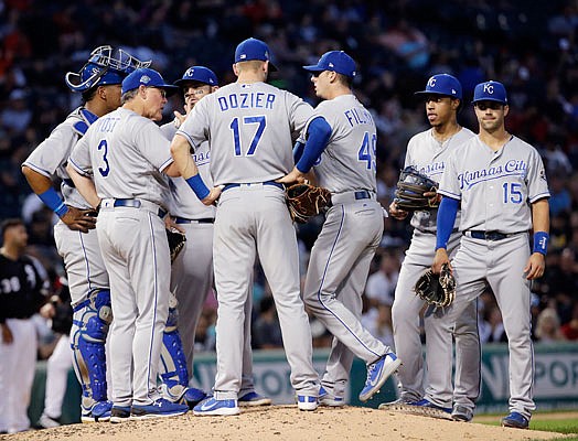 Royals manager Ned Yost (3) talks to his team during a meeting on the mound in the third inning of Friday night's game against the White Sox in Chicago.