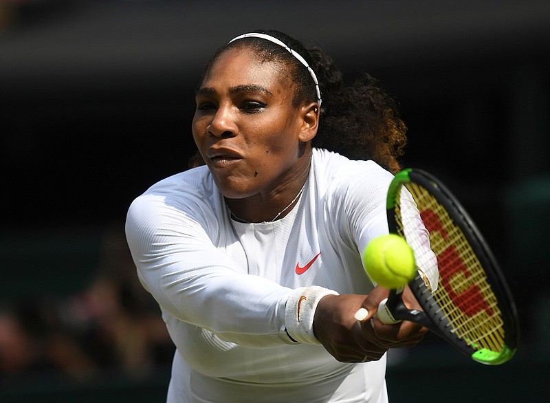 Serena Williams of the US returns a ball to Julia Goerges of Germany during their women's semifinal match at the Wimbledon Tennis Championships in London, Thursday July 12, 2018. (Neil Hall/Pool via AP)