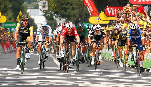 Dylan Groenewegen (left) and Andre Greipel (center) sprint to cross the finish line Saturday to win Stage 8 of the Tour de France with a start in Dreux and a finish in Amiens, France.