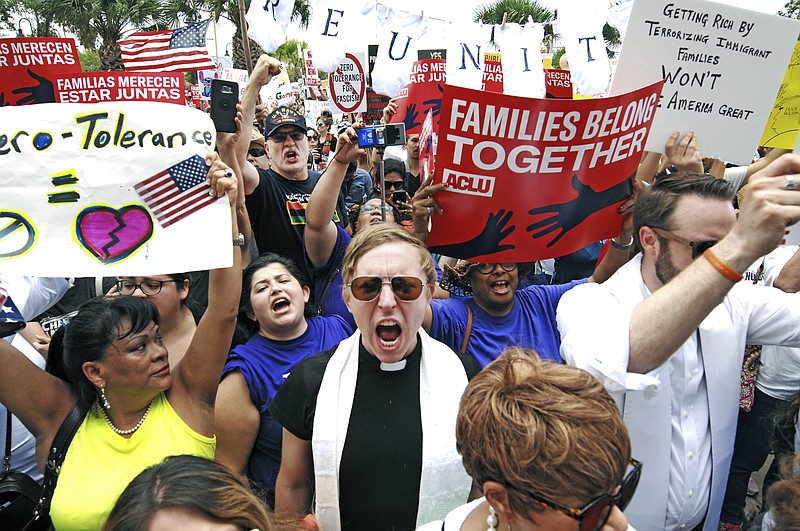 FILE - In this June 28, 2018 file photo, protesters chant "Families belong together!" as they walk to the front doors of the federal courthouse in Brownsville, Texas, to bring attention to the U.S. immigration policy. A federal judge, responding to a plan to reunify children separated at the border, said he was having second thoughts about his belief that the Trump administration was acting in good faith to comply with his orders. The Justice Department on Friday, July 13 filed a plan to reunify more than 2,500 children 5 years old and older by a court-imposed deadline of July 26 using “truncated” procedures to verify parentage and perform background checks that excludes DNA testing and other steps it took to reunify children under 5. The administration said the abbreviated vetting puts children at significant safety risk but is needed to meet the deadline.  (Miguel Roberts/The Brownsville Herald via AP, File)