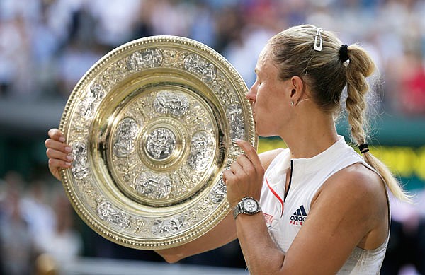 Angelique Kerber kisses the trophy after winning Saturday's women's singles final match against Serena Williams at the Wimbledon Championships in London.