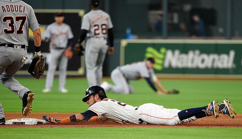 Houston Astros' Josh Reddick, right, slides into second for a double during the first inning of a baseball game against the Detroit Tigers, Saturday, July 14, 2018, in Houston. (AP Photo/Eric Christian Smith)