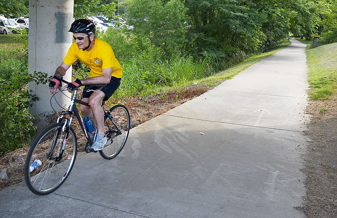 A biker makes his way down the bike trail, that begins on Dunklin Street, Monday afternoon.