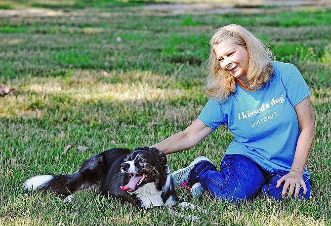 Linda Franchini and Harley pause in the shade to cool off for a few moments while playing frisbee earlier this week in north Jefferson City. For multiple reasons, primarily to aid in her post-stroke recovery, Linda Franchiniu decided to get a dog. She decided on Harley, a now 2-year-old border collie, who is included in most of her outdoor activities.