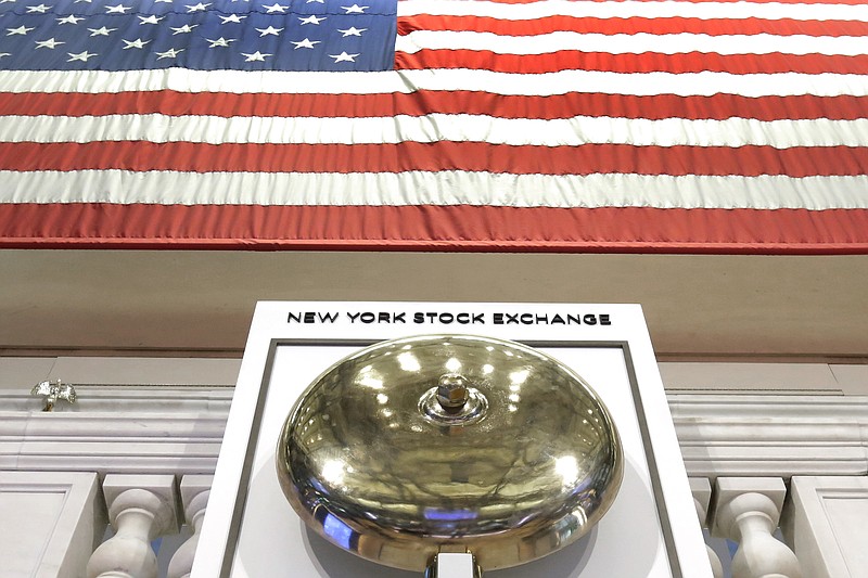 FILE- In this May 17, 2018, file photo, an American flag hangs above the bell podium on the floor of the New York Stock Exchange. The U.S. stock market opens at 9:30 a.m. EDT on Monday, July 16. (AP Photo/Richard Drew, File)