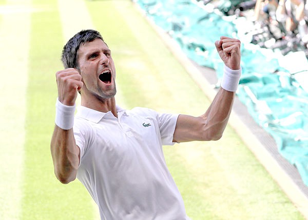 Novak Djokovic celebrates winning Sunday's men's singles final match against Kevin Anderson at the Wimbledon Championships in London.