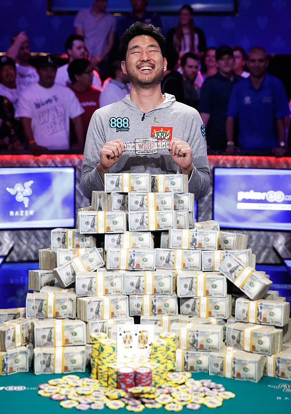 John Cynn smiles as he poses after winning the World Series of Poker main event Sunday in Las Vegas.