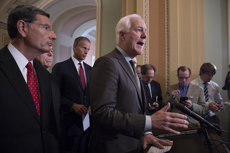 Senate Majority Whip John Cornyn, R-Texas, center, joined by, from left, Sen. John Barrasso, R-Wyo., Sen. Roy Blunt, R-Mo., and Sen. John Thune, R-S.D., tell reporters they are aiming to confirm Supreme Court nominee Brett Kavanaugh in time for the opening of the high court's term in October, during a news conference on Capitol Hill in Washington, Tuesday, July 17, 2018. (AP Photo/J. Scott Applewhite)