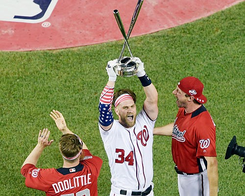 Bryce Harper of the Nationals holds up the trophy Monday night after winning the the Major League Baseball Home Run Derby in Washington.