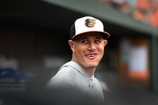 Manny Machado of the Orioles smiles in dugout after leaving during the sixth inning of Sunday's game against the Rangers in Baltimore.