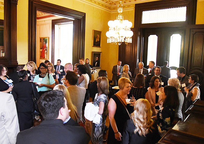 Participants in the Governor's Leadership Program gather in the Governor's Mansion on Monday to greet each other before a dinner hosted by Gov. Mike Parson.