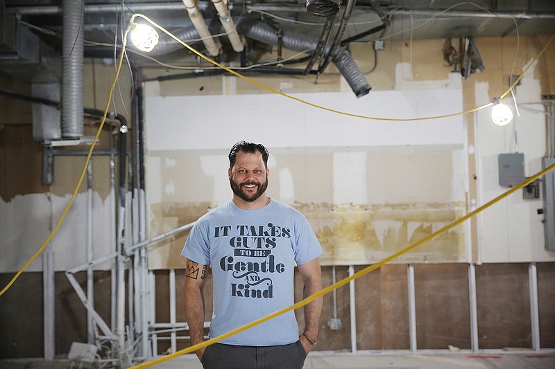 Chef Chad Houser, founder of Cafe Momentum, stands for a portrait at Thanks-Giving Square in downtown Dallas on June 29, 2018.  Houser plans to dish out a lot more from Cafe Momentum's community services center. The space, now under construction, will bring in additional resources for youth outside the restaurant.    (Andy Jacobsohn/The Dallas Morning News via AP)