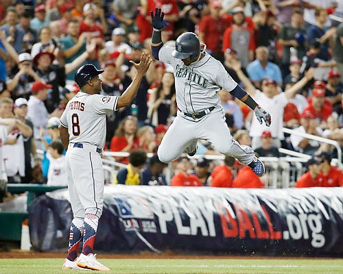 Jean Segura of the Mariners celebrates his three-run homer in the eighth inning of Tuesday night's All-Star Game in Washington.