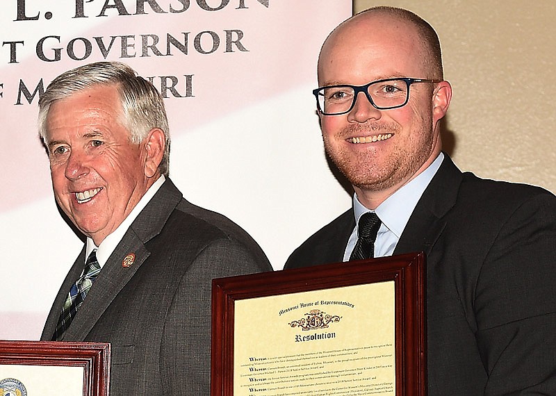 This May 7, 2018 file photo shows Mike Parson, then Missouri's lieutenant governor, and state Rep. Travis Fitzwater, right, handing out proclamations to service award winners during a ceremony at the Missouri Capitol. As governor, Parson last week vetoed a popular STEM and computer science curriculum bill that had been championed by Fitzwater. Parson claimed the bill favored one specific company to be an online curriculum provider.