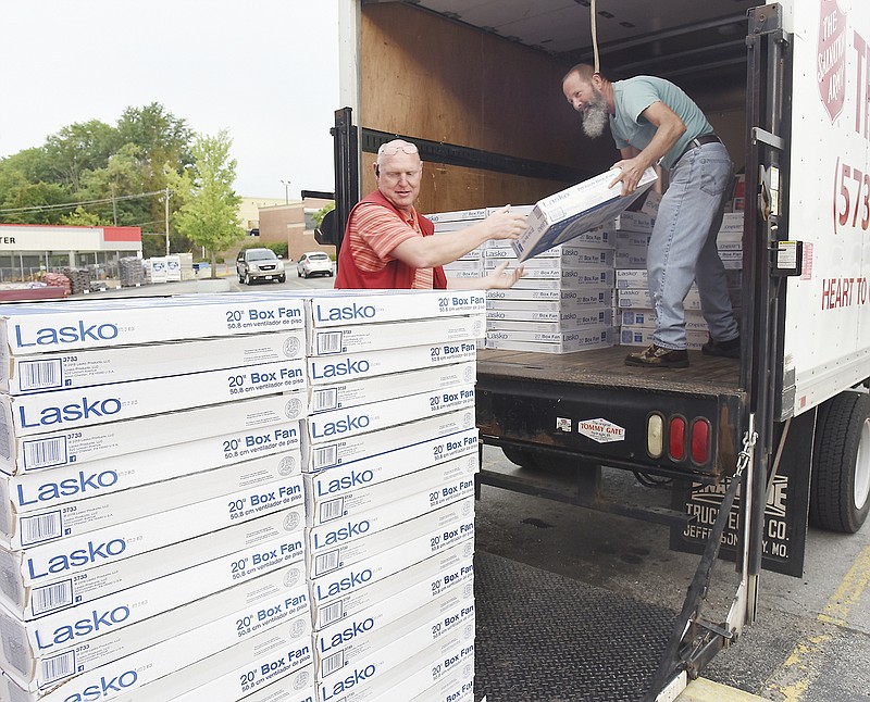 Julie Smith/News Tribune
Randy Miller, Jefferson City Westlake Ace Hardware general manager, in foreground, assists the Salvation Army's Tom Brant load two pallets of box fans onto the box truck Thursday morning at the Missouri Boulevard store. Brant will then deliver the fans to The Salvation Army offices where they'll be distributed. This year's collection of 94 fans made it the store's most successful fan drive to date. 