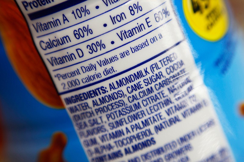 This Feb. 16, 2017, photo shows the ingredients label for almond milk at a grocery store in New York.  Soy and almond drinks don't come from cows, so regulators may soon ask them to stop calling themselves "milk." The Food and Drug Administration signaled plans to start enforcing a federal standard that defines "milk" as coming from the "milking of one or more healthy cows." That would mark a change for the agency, which has not aggressively gone after the proliferation of plant-based drinks labeled as "milk."  (AP Photo/Patrick Sison)