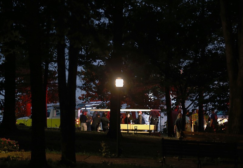 Emergency responders work at Table Rock Lake after a deadly boat accident in Branson, Mo., Thursday, July 19, 2018. A sheriff in Missouri said a tourist boat has apparently capsized on the lake, leaving several people dead and several others hospitalized.