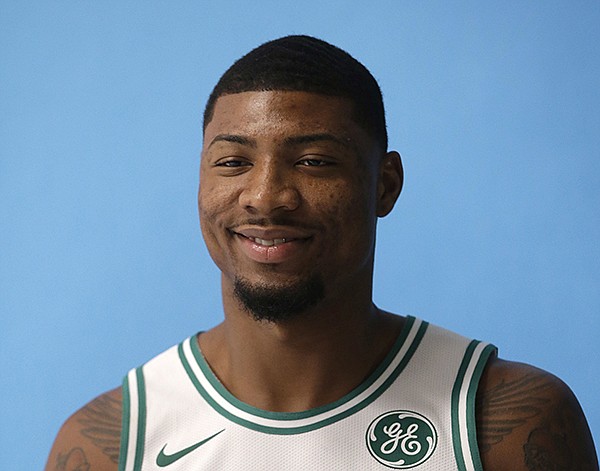 In this Sept. 25, 2017, file photo, Boston Celtics' Marcus Smart poses during NBA basketball media day, in Canton, Mass. The Celtics have re-signed guard Marcus Smart. A person with knowledge of the agreement tells The Associated Press that Smart signed a four-year, $52 million contract with the Celtics. The person spoke to the AP on condition of anonymity Thursday, July 19, 2018,  because the team did not disclose the terms of the contract. 