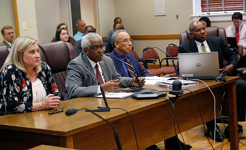 Noxubee County School District Superintendent Roger Liddell, right, district lead attorney Bennie L. Jones Jr., second from right, Noxubee County School District board chairman Albert Williams, and county school district financial officer Pam Norris, listen to questions, during a hearing in Jackson, Miss., Wednesday, July 18, 2018, on the large number of violations found in an investigative audit of Mississippi's accreditation standards for public schools by the Noxubee County School District. (AP Photo/Rogelio V. Solis)