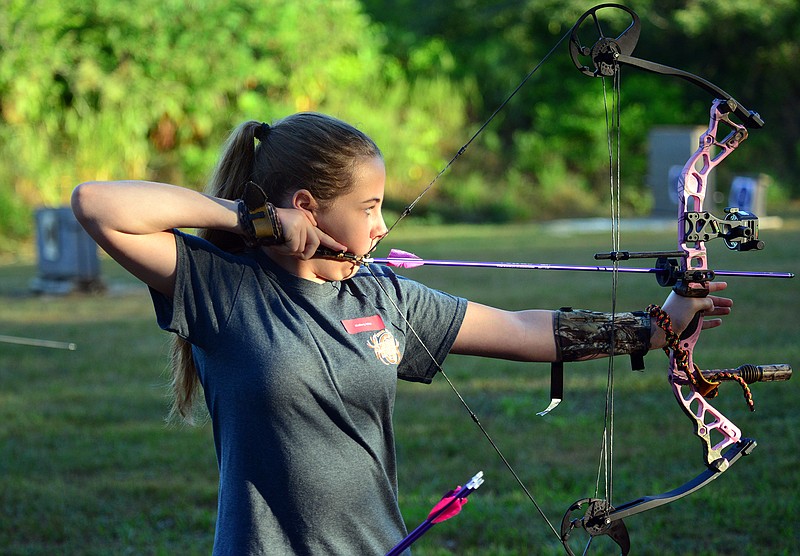 Mallory Witt, 10, of the Miller County 4-H, takes aim in her archery event at the United Sportsmen's Club on Saturday, July 21, 2018. The Cole County 4-H hosted the shooting sports events ahead of the Jefferson City Jaycees Cole County Fair. 