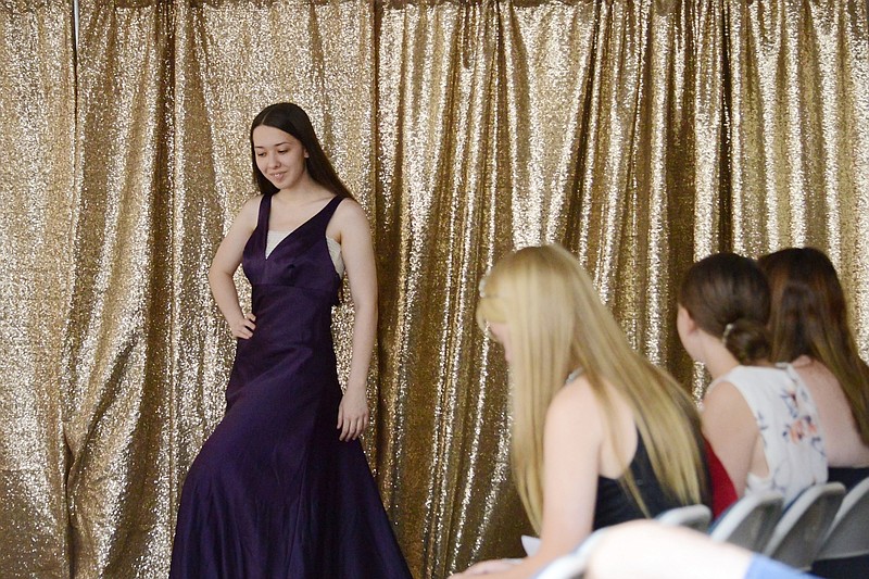 Eileen Shafer, 16, walks down the catwalk Saturday, July 21, 2018, as she models her dress for the bargain fashion fun category at the Cole County 4-H FFA fashion revue.