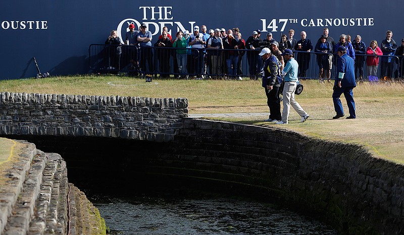 Kevin Kisner of the US talks to officials after hitting the ball into the water on the 18th hole during the second round of the British Open Golf Championship in Carnoustie, Scotland, Friday July 20, 2018. (AP Photo/Alastair Grant)