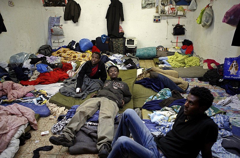 In this Monday, Feb. 25, 2008, file photo, Eritrean refugees sit in a shelter in Tel Aviv, Israel. The startling and sudden thaw between longtime enemies Eritrea and Ethiopia is opening up a world of possibilities for the countries' residents: new economic and diplomatic ties, telephone and transport links and the end to one of the most bitter feuds between neighbors. But the fledgling peace is raising new questions for Eritrea's diaspora, tens of thousands of people who fled the Eritrean government's tight grip, a rigid compulsory military and endemic poverty who are cautiously waiting to see how the truce will shape their homeland and perhaps offer them a chance to return. (AP Photo/Tara Todras-Whitehill, File)