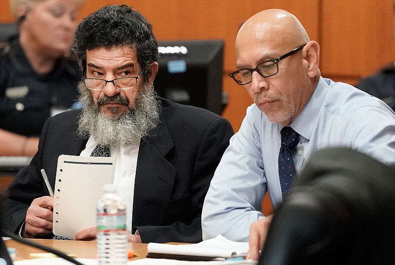In this June 25, 2018 photo, Ali Mahwood-Awad Irsan, left, sits in court with his defense attorney Rudy Duarte, right, in Houston. Irsan, a 60-year-old Jordanian-American, is charged with capital murder, accused of killing his daughter's husband and her best friend, an Iranian activist.  (Melissa Phillip/Houston Chronicle via AP)