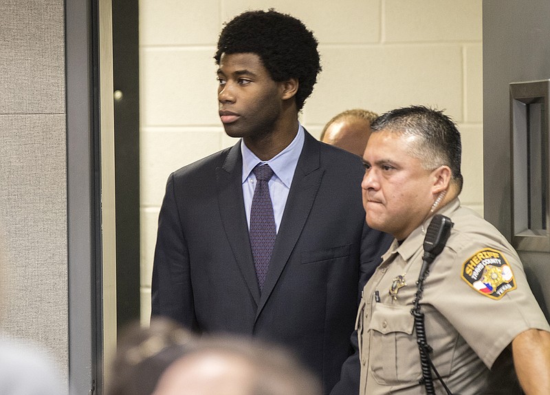 In this July 11, 2018, file photo, Meechaiel Criner, accused of killing University of Texas student Haruka Weiser in April 2016, is escorted into a courtroom in Austin, Texas. A jury on Friday, July 20, 2018, found Criner guilty of capital murder. Criner, a foster care runaway at the time of the slaying, received an automatic life sentence. He was ineligible for the death penalty because he was 17 when the crime occurred. (Ricardo Brazziell/Austin American-Statesman via AP, File)