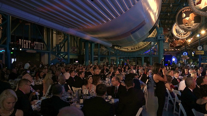 The black-tie Apollo Celebration Gala is held under a Saturn V rocket at the Kennedy Space Center in Cape Canaveral, Fla., on Saturday, July 21, 2018. The event kicked off a yearlong celebration of the upcoming 50-year anniversary of the first moon landing, and featured a panel discussion by astronauts, an awards ceremony and an auction of space memorabilia. (AP Photo/Alex Sanz)