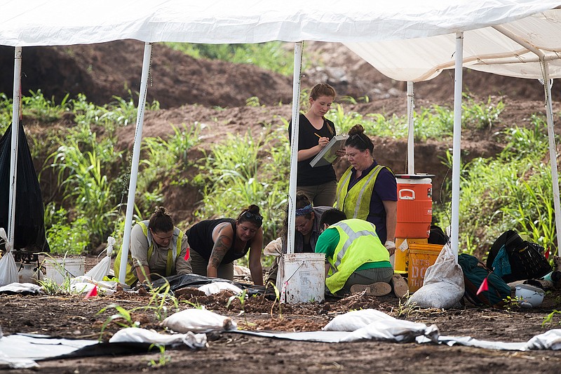 Students hand excavate at a historic burial site, July 16, 2018,  at the site of the James Reese Career and Technical Center in Sugar Land, Texas, where a historic cemetery was discovered earlier this year. Archaeologists have determined that the remains found so far are of African-Americans, all but one of whom was male.  Marie D. De Jesus /Houston Chronicle via AP)