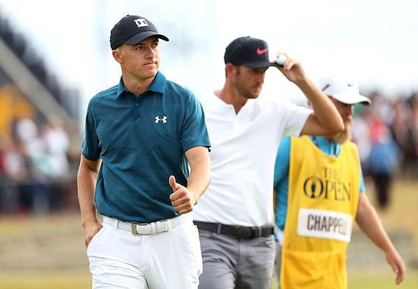 Jordan Spieth and Kevin Chappell walk off the course after Saturday's third round of the British Open in Carnoustie, Scotland.