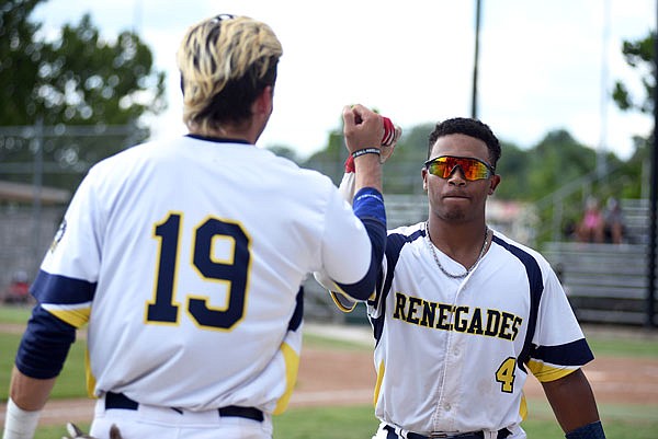 Mike Million (right) of the Renegades fist-bumps teammate Jake Slunder after hitting a home run during the first game of Saturday's doubleheader against the Outlaws at Vivion Field.