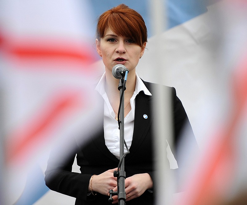 In this photo taken on Sunday, April 21, 2013, Maria Butina, leader of a pro-gun organization in Russia, speaks to a crowd during a rally in support of legalizing the possession of handguns in Moscow, Russia. Butina, a 29-year-old gun-rights activist, served as a covert Russian agent while living in Washington, gathering intelligence on American officials and political organizations and working to establish back-channel lines of communications for the Kremlin, federal prosecutors charged Monday, July 16, 2018. (AP Photo)