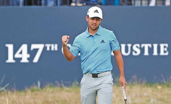 Xander Schauffele pumps his fist after a birdie on the 18th hole during Saturday's third round of the British Open in Carnoustie, Scotland.