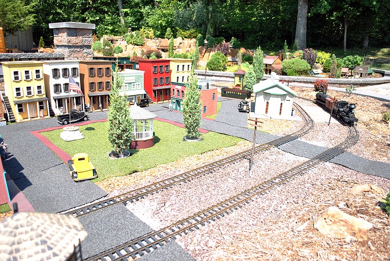 (Photo by Samantha Pogue/News Tribune) Paul Heiberger's large train collection was put to good use by incorporating a small town, a family farm, logging company and most recently a mine in his massive outdoor train set, which can run three locomotives simultaneously.  