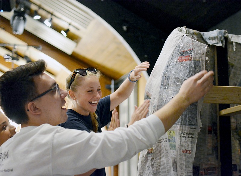 Sally Ince/ News Tribune
Mattew Rayme, left, and Katie Farr, both counselors at Capital City Productions Camp build Shrek's swamp house out of paper mache Tuesday during rehersal for the Shrek Jr. production. The camp was made possible in part by the large number of people who volunteered to be couselors and teachers for the camp. Campers were given the opportunity to gain hands on experince in different aspects theatre while also gaining friendships and learning how to give back to the community. 