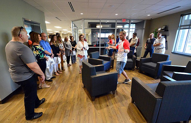 PFSbrands employees give guided campus tours Friday during the company's corporate office grand opening in Holts Summit. The employee-owned company has plans to add 100-plus more jobs by 2025.