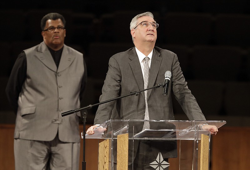 Indiana Gov. Eric Holcomb speaks during the funeral for Horace Coleman, Belinda Coleman, Irvin Coleman, Angela Coleman and Maxwell Coleman Ly, Saturday, July 28, 2018, in Indianapolis. Nine members of the Coleman family were killed in a duck boat accident at Table Rock Lake near Branson, Mo. (AP Photo/Darron Cummings)