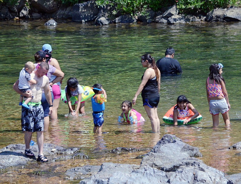 Sally Ince/ News Tribune
Young children wear flotation gear Sunday July 8, 2018 as they play in a shallow part of the Johnson Shut-Ins in Middle Brook, MO near supervising adults. Missouri State law requires children under 7 years of age wear a life jacket while on a water boat vessel. Missouri Highway Patrol also highly encourages children have a life jacket or flotation device and close adult supervision while near bodies of water.