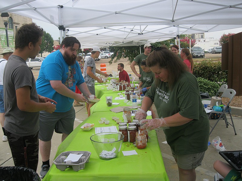 People sample varieties of salsa during the Texarkana, Texas, Farmers' Market's ninth annual Best Salsa Contest on July 28, 2018, downtown. 
